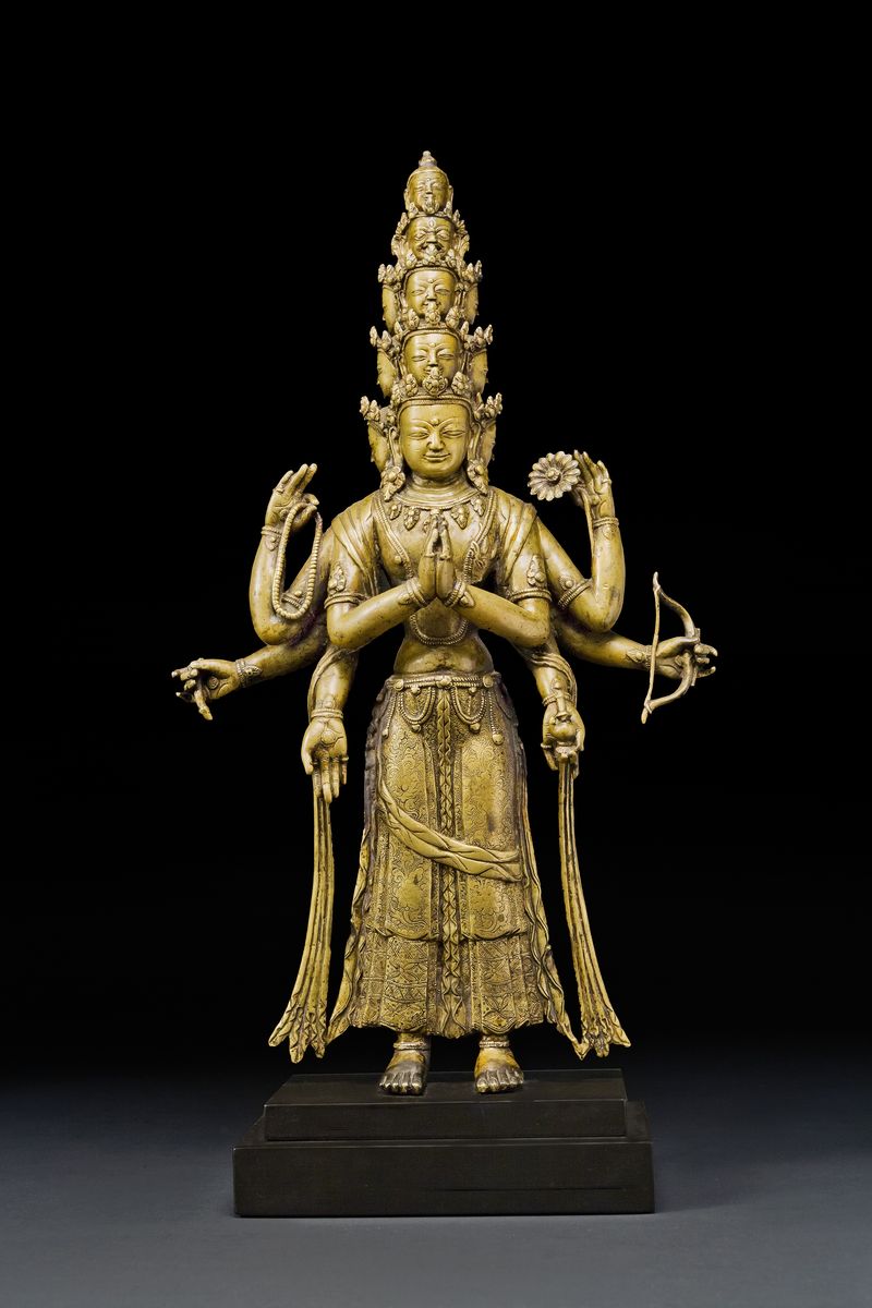 Standing figure of the Eleven-faced Avalokiteshvara on a dark ground